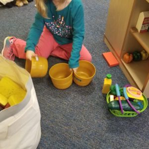 Girl playing with cooking toys